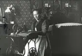 Sömmerskan Anna Wester i sitt rum på andra våningen i bönhuset, Åby, Funbo socken, Uppland före år 1900