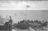 Sekelskiftsklädda damer och herrar beundrar utsikten. Damerna har paraplyer, som skydd mot solen. Vykortstext: Utsikt från Varbergs fästning. Skriven text: Varberg, d. 24/5 1905. Vykortsförlag: Mathilda Ranch Imp