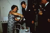 Margit Wannerberg serverar kaffe. På kalas med närmaste vänner (okända) i Pixbo, efter 1958.