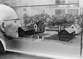 Wilhelm Wilén studerar Postmuseums modell av posthuset i
Grisslehamn.