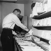 Lantbrevbärare Knut Svensson, Växjö, sorterar dagens post, 1953.