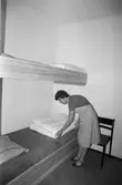 Kvinna iordningställer säng på Torrekulla turiststation i Kållered, år 1984.
Fotografi taget av Harry Moum, HUM, Mölndals-Posten.
