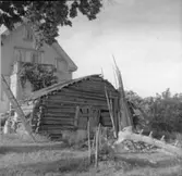 Vedboden på gården Munken Nössemark,  fr. SV. Sågbocken är gjord av en trädstam.