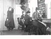 Personal hos Mathilda Ranchs fotoateljé 1906. Sittande närmast väggen: Alvina Pihl.