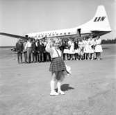Barn och ungdomar vinkar för avfärd med Linjeflyg på Axamo, Jönköpings flygplats, på 1960-talet.