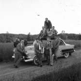 Conny Richs orkester på turné på 1950-talet. Vid trumman på taket sitter Rune Ekström och bakom honom står pianisten Per Gerdin, Rolf Ekström står och lutar sig längst fram mot bilens motorhuv.