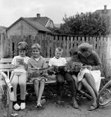 I kvarteret Loke vid Vättergatan i Huskvarna sitter Margareta Ståhl (1) och Lejon (2), två pojkar och en kvinna på en bänk och läser serietidningar, bland annat Walt Disneys Kalle Anka & Co och Sjörövarna med Krutmysteriet. Mellan dem ligger en hög väl lästa tidningar.