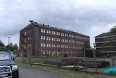 Kontorsbyggnader i rött tegel med fastighetsbeteckning Pottegården 2 och gatuadress Kråketorpsgatan 18 i Åbro industriområde i Mölndal. Fotografi taget den 31 juli 2014. Byggnadsdokumentation inför rivning. Diarienummer: BN 1083/2019.