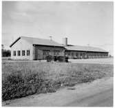 Vägstation C6, Tierp. Verkstads- och garagebyggnad invid väg.