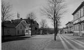 Kungsgatan norrut vid Skolgatan med kvarteret Fjolner t.v. i mellanplanet år 1928.