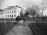 Stadsingeniör Nycader till häst framför Tekniska skolan.