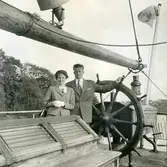 Mary Ekman (1920 - 1988, född Ekdahl) och maken Björn Ekman (1913 - 1992) står på en segelskuta, troligtvis 1960-tal. Okänd plats.