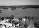 Vy över en större gård vid en sjö.