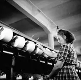 En kvinna arbetar med att rulla upp tråd, Nääs fabriker.