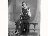 Fiolspelande kvinna sitter på en bänk. (Se även bild MR2_2134)