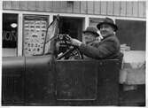 Stolt chaufför med passagerare på Storgatan i Nora, 1948