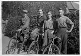 Fyra cyklister framför häck, 1930-tal