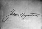 Namnteckning av Johan Bryntesson huggen i sten, 1938