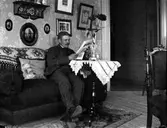 Man läser tidningen i soffan, 1920-tal