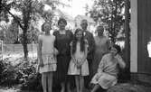 Grupp vid husknut, 1930-tal