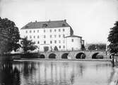 Människor går på Kanslibron vid Örebro slott, 1890-tal