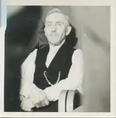 Porträtt av Efraim Magnusson (1876-1960) sittandes i en stol, Apelgården 1:3 okänt årtal.