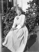 Kvinna framför hus, 1918