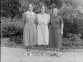 Tre kvinnor fotograferade vid en rabatt, troligen utanför Ranchs Atelier. Belden beställd av Svea Gustavsson.