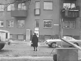 Kvinna på väg över gatan, 1960-tal