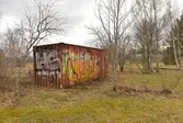 Nedklottrad container vid Åstadalsvägen, 2016-04-04