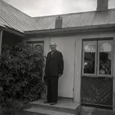 En man vid en dörr till en stuga.