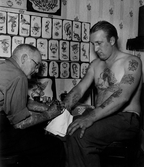 Tatueraren Charlie Nilssons, sannolikt i sin tatueringsverkstad i Lervik.