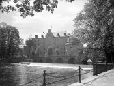 Personer promenerar på kanslibron vid Örebro slott, 1920-tal