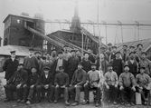 Järnbruksarbetare framför bron till kransen av rostugnen vid Axmar bruk, Hamrånge.