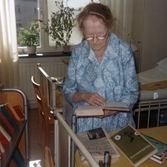 Patient läser en bok från bokvagnen på Regionsjukhuset, 1965