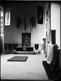 Stockholmsutställningen 1930
Mässhakar, altarklädsel, mattor och fanor  med mera i utställningssal utformad som ett kyrkorum.