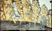 Del av väggmålning. En man, herde, med en get framför bleknande löv.