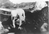 Bykning i Hagabäcksån, Gurli Bengtsson (1902 - 1993) tvättar 1928. Gurli arbetade som hushållerska hos bröderna Gustav och Albert Bengtsson vid Vommedal Västergård 3:3 