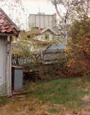 Längs ner i Stalleliden, Mölndals Kvarnby, omkring 1975-1980. Till vänster Roten M 13, gaveln till stallet. I mitten Roten M 1, Götaforsliden 6. I bakgrunden SOABs silobyggnad.