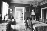 Skrivbord och kristallkrona över matbord i Karlslunds herrgård, 1981