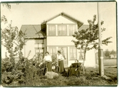 Dagny Sundlings mor Karolina och två systrar i trädgård framför hus.