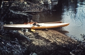 Kanot uppdragen på stranden, 1970-tal