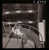 561 A Operareportage för tidningen Vi. En kvinna sitter på balkong i salongen.