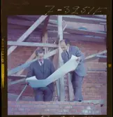 585/8 Facit Tokyo Daberg. Två män i kostym står på ett bygge och studerar en ritning.