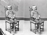 Pojkporträtt. Troligen minsta brodern av Mathildas syskon, Erik Ranch, som sitter på en stol. Han ska då vara i 6-årsåldern.