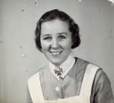 Ateljéporträtt av Ester Johansson (1914 - 2008, gift Faldahl), vårdbiträde/undersköterska på Mölndals lasarett 1939 - 1941. Bilder från fotoalbum, tagna från södra sidan av Länsmansgatan vid Mölndals lasarett/sjukhus 1939 - 1941 på bland annat givarens mor Ester (född Johansson) tillsammans med kollegan/väninnan Aina Englund. De arbetade på den manliga kirurgavdelningen som vårdbiträden/undersköterskor.
Relaterade motiv: 2024_1542 - 1617.