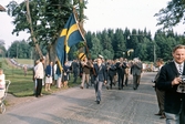 Brevens hornmusikkår följer flaggbäraren, ca 1967