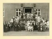 Ett societetsbröllop på Örtofta slott. 
Bröllop 19/5 1921 mellan fröken Stina-Brita Bennet, dotter t. friherren och godsägaren Jacob Erland Bennet och h.h. Anna, f. Rosenblad, och greve Ove Thott. 
Man har samlats vid dubbeltrappan vid huvudingången. På stenreliefen över porten syns ätterna Stenbocks och
Barnekows vapen, året 1728 och följande inskription: 