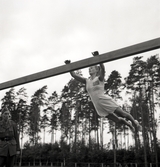 Gymnastikuppvisning på bom av kvinnlig gymnast på Gymnastikens dag.