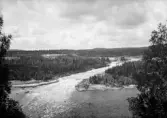 Åkvissleforsen med den gamla järnvägsbron i bakgrunden. 